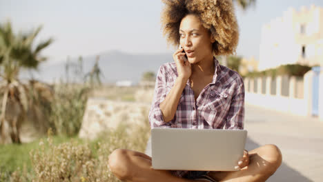 Young-African-Woman-Working-On-Laptop-In-Nature.