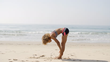 Female-Athlete-Doing-Exercise-On-Beach