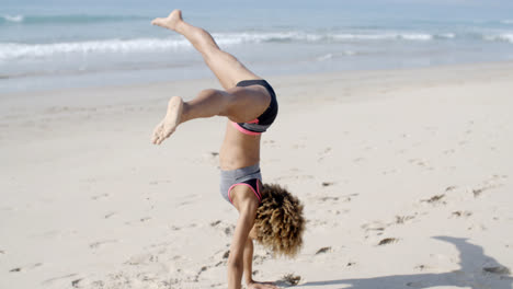 Young-Woman-Doing-Cartwheel-On-Beach
