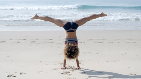 Girl-Doing-A-Handstand-On-A-Beach