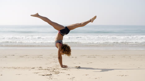 Young-Woman-Doing-Cartwheel-On-The-Beach