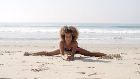 Woman-In-Yoga-Position-At-The-Beach