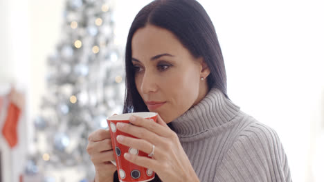 Woman-enjoying-a-cup-of-Christmas-coffee