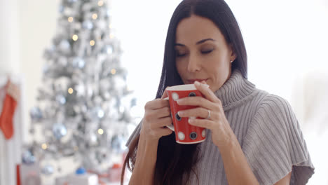 Woman-enjoying-a-cup-of-Christmas-coffee