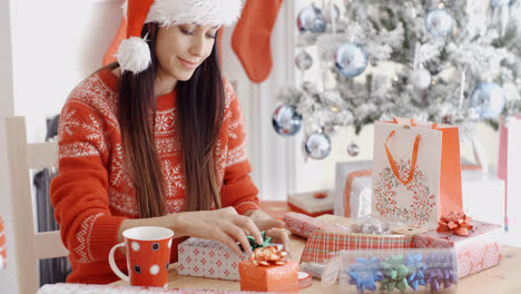 Young-woman-decorating-her-Christmas-gifts
