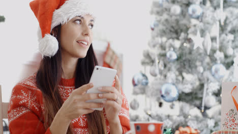 Attractive-woman-checking-for-Christmas-messages