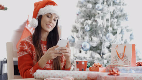 Attractive-woman-checking-for-Christmas-messages