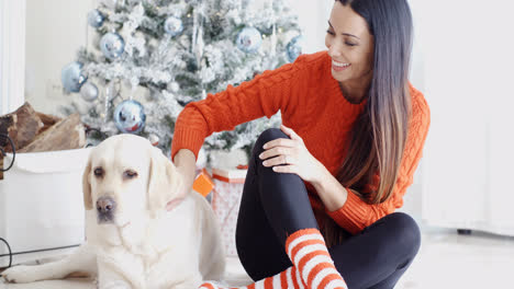 Laughing-young-woman-with-her-dog-at-Christmas