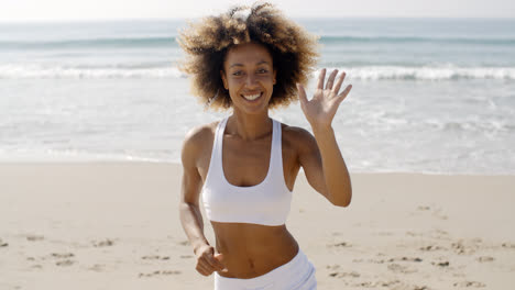 Woman-Running-On-The-Beach-And-Waving