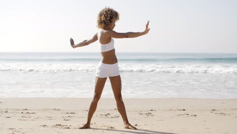 Woman-Practices-Yoga-On-A-Beach