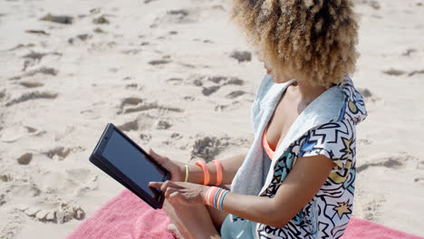 Woman-Uses-Tablet-On-The-Beach