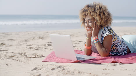 Woman-On-The-Beach-Using-A-Computer