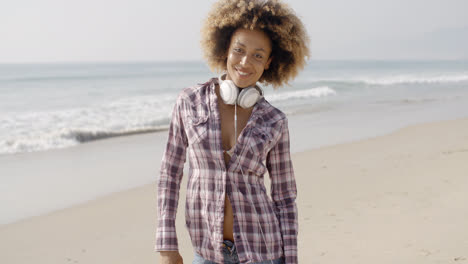 Girl-With-Headphones-Walking-On-The-Beach