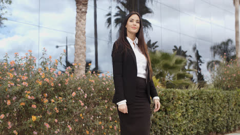 Stylish-businesswoman-standing-outside-her-office