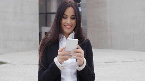 Attractive-businesswoman-checking-her-mobile-phone