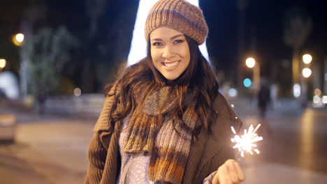 Pretty-young-woman-celebrating-with-a-sparkler