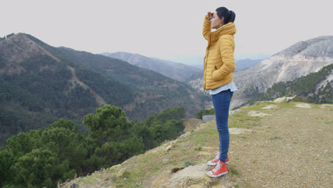 Young-woman-looking-out-over-mountain-scenery