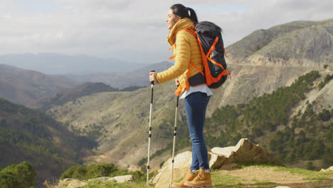 Young-woman-hiker-standing-overlooking-a-valley