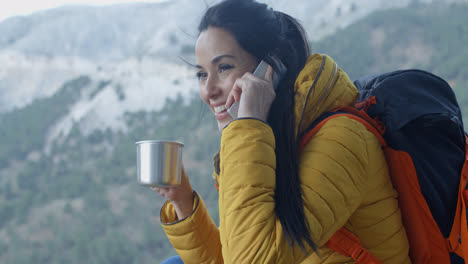 Happy-female-hiker-on-phone