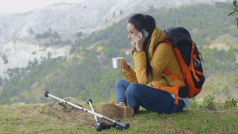 Hiker-talking-on-phone-during-a-break