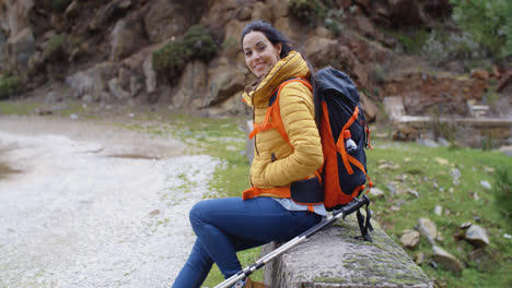 Smiling-young-woman-on-a-mountain-trail
