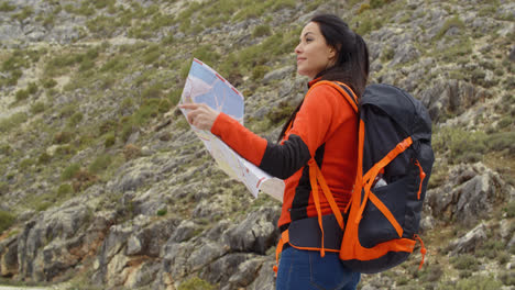 Young-woman-out-hiking-checking-a-map