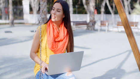 Young-woman-with-a-laptop-in-a-park