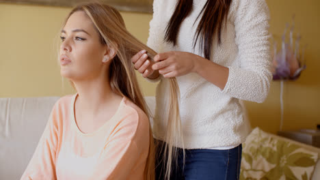 Woman-Looking-Away-While-Friend-is-Fixing-her-Hair