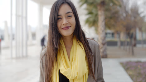 Joyful-grinning-woman-outside-in-yellow-scarf