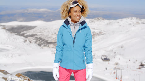 Beautiful-woman-in-ski-outfit-standing-on-mountain