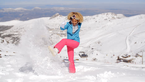 Cute-woman-in-skiing-clothes-kicking-snow