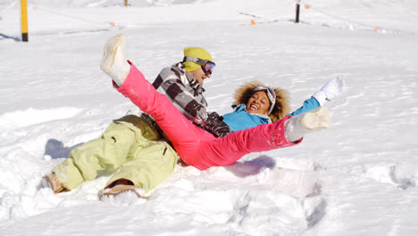 Young-couple-enjoying-a-frolic-in-the-snow