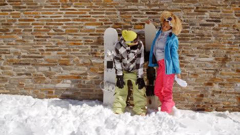 Snowboarder-with-happy-friend-in-front-of-wall
