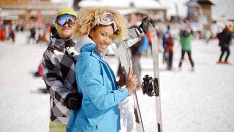 Man-flirting-with-woman-holding-snowboard