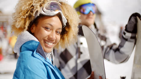 Close-up-of-skier-holding-snowboard