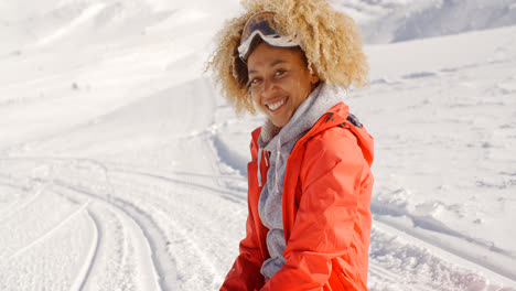 Close-up-of-cheerful-woman-on-snowy-hill