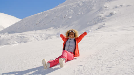 Rejoicing-woman-sliding-down-snowy-hill