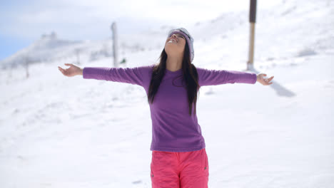 Happy-young-woman-embracing-the-winter-sun