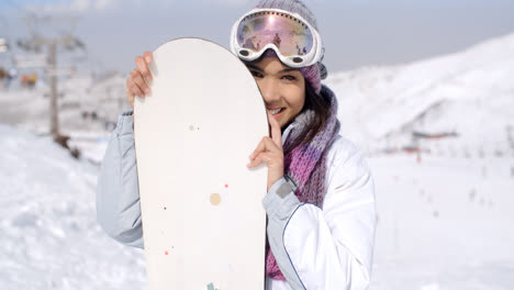 Laughing-young-woman-with-her-snowboard