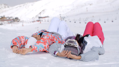 Two-skiers-laying-on-the-ground