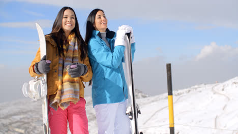 Two-young-woman-with-their-snowboards