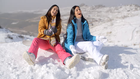 Two-gorgeous-laughing-young-woman-in-snow