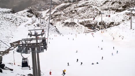 View-from-a-ski-lift-of-skiers-below-on-a-run