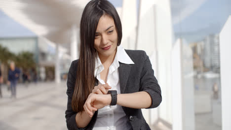 Young-woman-checking-her-wristwatch-for-the-time