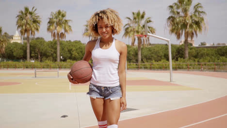 Sexy-young-woman-posing-with-a-basketball
