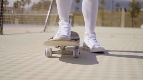 Worms-eye-view-of-skater-wearing-white-gym-shoes