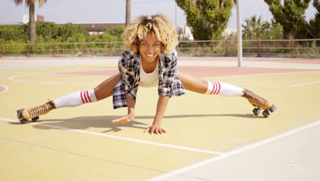 Fun-young-woman-doing-the-splits-on-skates