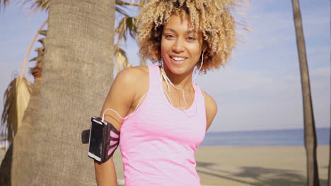 Confident-fit-woman-with-arm-band-music-player
