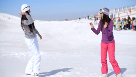 Two-young-women-having-a-snow-fight