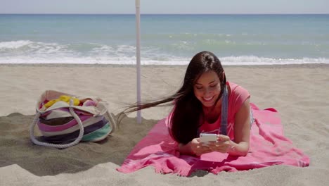 Junge-Frau-SMS-Beim-Entspannen-Am-Strand